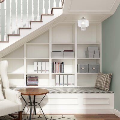 Home Office Design Creative space under stairs with white shelves